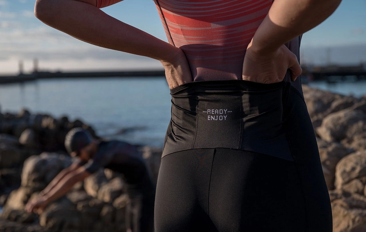 Back detail of female triathlete wearing the Trine Trisuit made by Enjoy.cc