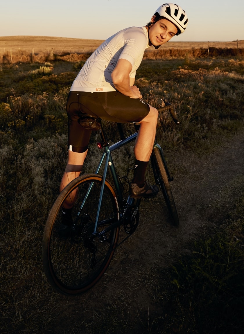 Male cyclist wearing the Chevron ecru mens Octane cycling jersey designed by Enjoy.cc