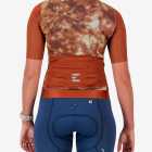 Back view of the ProXision women's cycling zipless jersey in a rust tie-dye design made by enjoy.cc